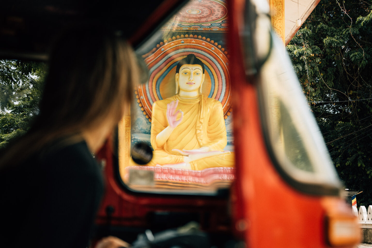 A Buddha statue view from inside of the tuktuk in Hambantota